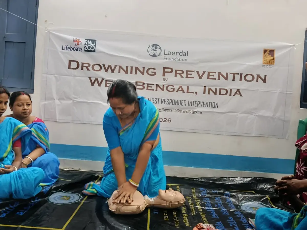 A woman practising chest compressions during community first-responder training