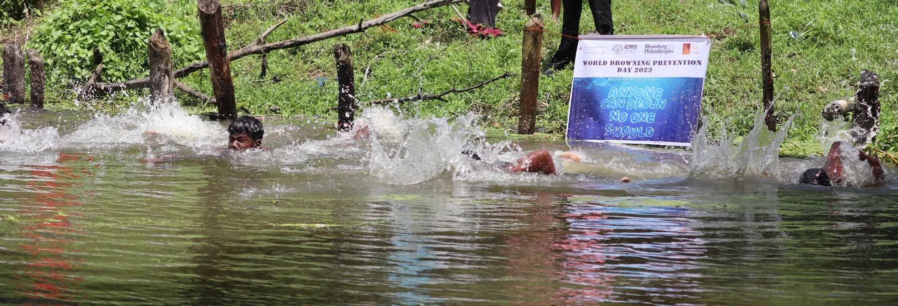 Adolescents practising swimming in a marked pond-based training area