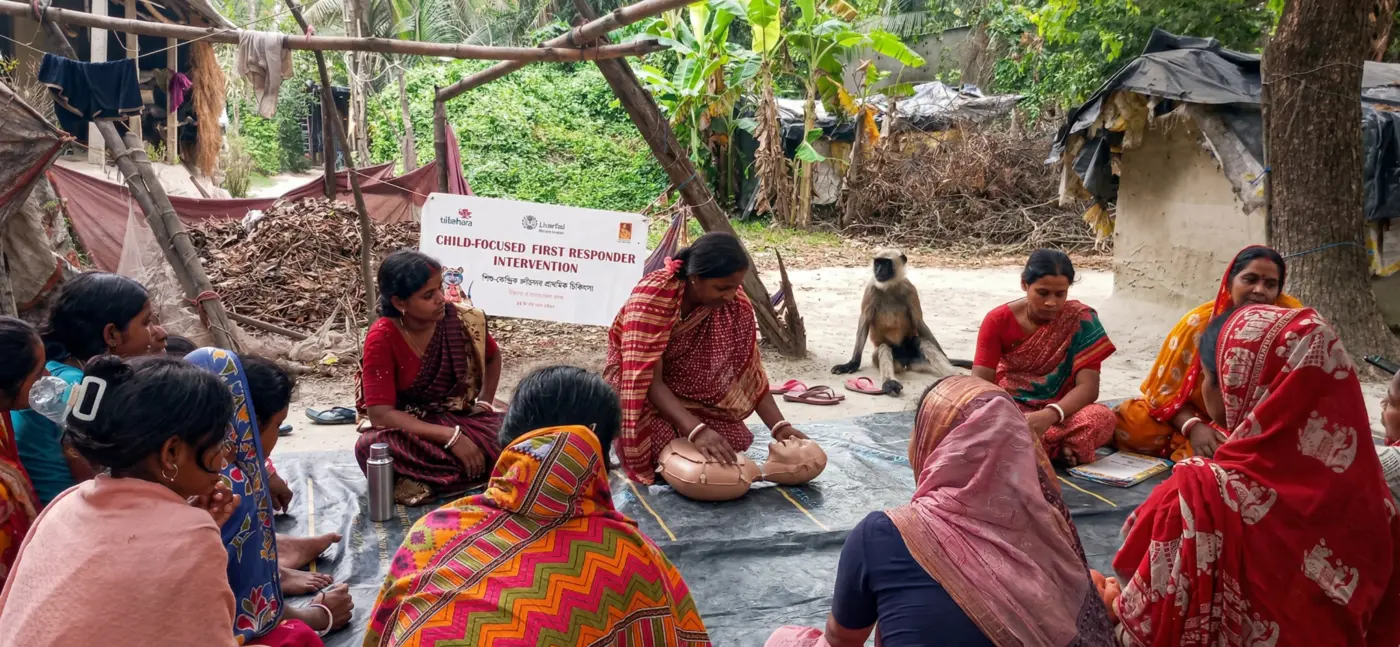 Women practising CPR on a training manikin during a community session